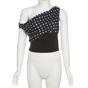 Detail view of one-shoulder polka dot crop top featuring asymmetrical draped design
