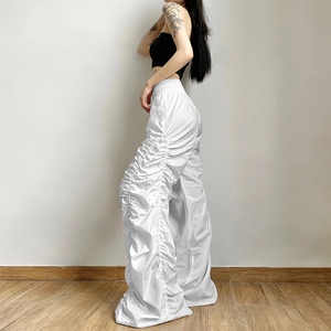White high-waisted wide-leg trousers with ruched side details and elastic waistband