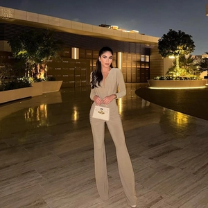 Elegant beige deep V-neck long sleeve jumpsuit with slim-fit wide-leg trousers