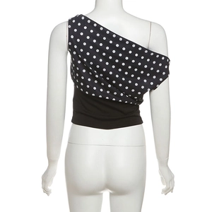 Rear view of polka dot one-shoulder crop top featuring a black waist panel on a mannequin