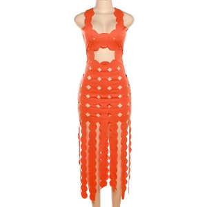 Detail of orange hollow-out dress showing scalloped edges and geometric cutouts