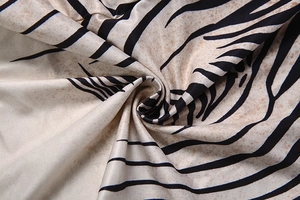 Macro detail of the floral print fabric showing abstract tropical leaf patterns and texture