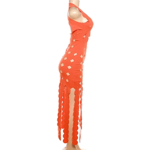 Detail of orange cutout dress featuring halter neck and unique circular fringe hemline