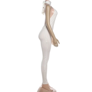 Side view of white halter neck backless jumpsuit on a mannequin showing tight fit
