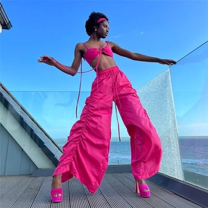 Detailed side view of high-waist ruched wide-leg pants with drawstrings in vibrant rose pink