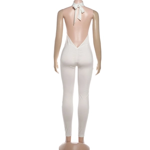 Detailed back view of white backless jumpsuit featuring ruched lifting detail
