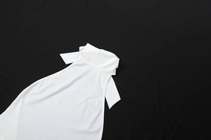 Flat lay of a white backless halter neck jumpsuit with ribbed texture and slim fit design