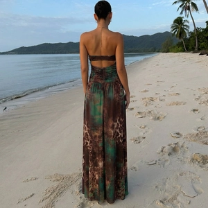Detail of backless halter dress with marble print and waist pleats on beach