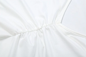 Detailed macro view of the white ruched stitching and fabric texture on a jumpsuit