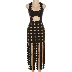 Detail showing laser-cut circular hollow patterns and round fringe on a black maxi dress