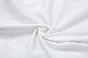 Close-up of white ribbed knit fabric texture showing spiral drape and soft twill weave detail