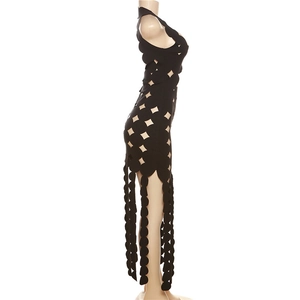Detail of creative cutout geometric patterns and wavy hem on a black sleeveless dress
