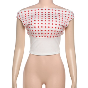 Close-up of one-shoulder cropped top with red polka dots and white elastic waist detail