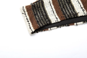 Detail of striped knit bikini set showing brown green stripes and fringed edges