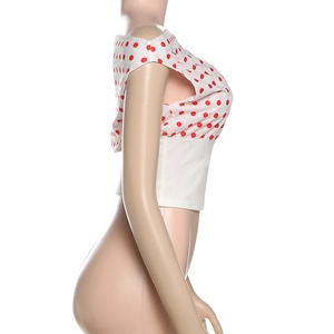 Detail of red polka dot off-shoulder crop top featuring a white elastic waist cincher