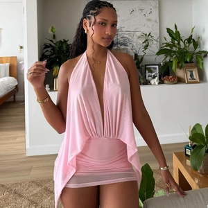 Detail of a pink halter neck dress with deep V-neck and ruched side mesh drapes