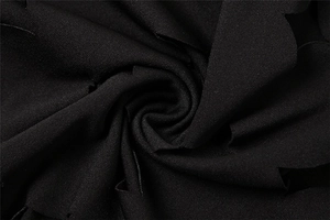 Macro shot of high-density black twill fabric showing fine texture and sleek drape
