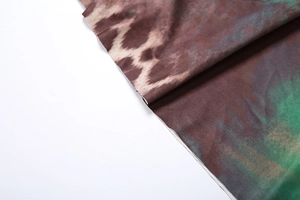 Close-up of leopard print fabric with green gradient on halter neck dress detail