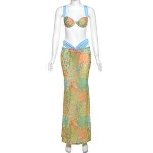 Detail view of vibrant paisley print on a bikini top and matching high-waist maxi skirt set