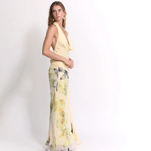 Three-piece floral set with yellow halter top and high-waisted printed maxi skirt