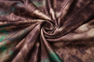 Detailed view of the brown and green tie-dye abstract print fabric texture