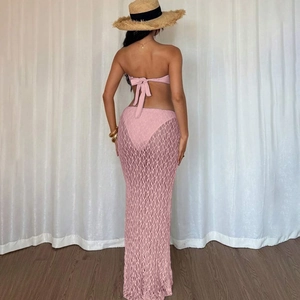 Detail view of pink lace beach cover-up with stylish tie-back design on long skirt