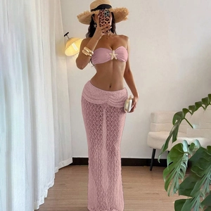 Detail of pink lace maxi skirt set featuring gold starfish ornament on tube top