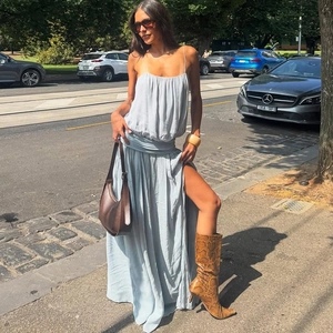 Detail of light blue sleeveless dress with waist pleats and a sexy side slit design