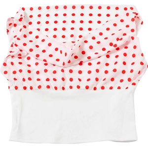 Detailed view of red polka dot pattern on a white cropped top with gathered elastic fabric