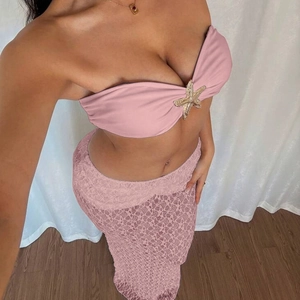 Detail of pink lace maxi skirt set with starfish gold accent on strapless top