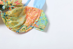 Detailed macro view of bohemian printed bikini top with bow tie and blue shoulder strap