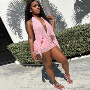 Detail of pink halter neck ruched mini dress with deep V-neck and open back design