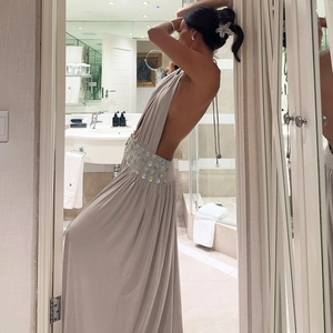 Detail of waist design with shell sequins on a backless halter maxi dress