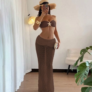 Detail view of the brown lace maxi skirt and bikini top with starfish ornament