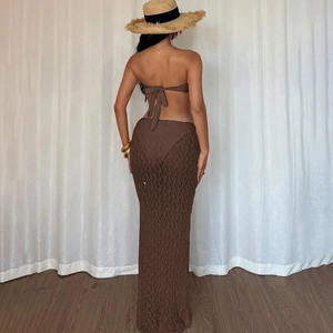 Detail view of brown two-piece swimwear with elegant lace hollow-out long skirt cover-up