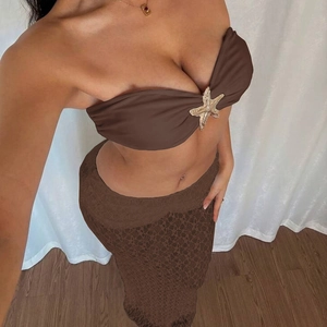 Detail of a brown lace two-piece set featuring a golden starfish bandeau accent