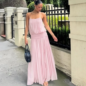 Close-up of light pink spaghetti strap chiffon dress with pleated waist and elegant drape