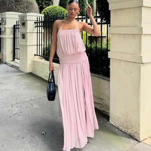 Detail of pink spaghetti strap dress with waist pleats and flowing pleated mesh skirt