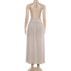 Detail of beige backless halter maxi dress with long neck ties and gathered waist structure