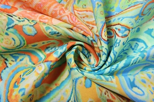 Detailed macro view of bohemian paisley print fabric with vibrant swirling patterns