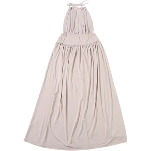 Detailed view of the halter neckline and shirred waist on the beige knit maxi dress