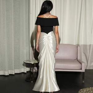 Detail of elegant off-shoulder contrast maxi dress showing ruched back satin texture