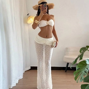 Detail of white lace maxi skirt and bandeau top with gold star accent for women