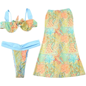 Detailed flat lay of a three-piece paisley bikini set with a matching long skirt