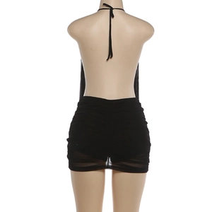 Detail of sexy backless halter neck dress with ruched bodycon design in black