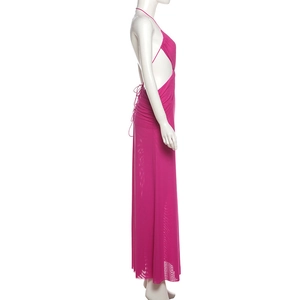 Detail view of rose pink halter neck maxi dress with side cut-outs and lace-up back