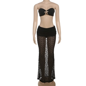 Detail of gold starfish metal ornament on sexy black lace tube top and maxi skirt set