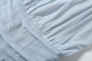 Detail of light blue mesh fabric with elegant gathered texture and inner lining