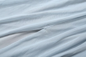 Detail of light blue mesh fabric with fine texture and smooth knitted inner lining