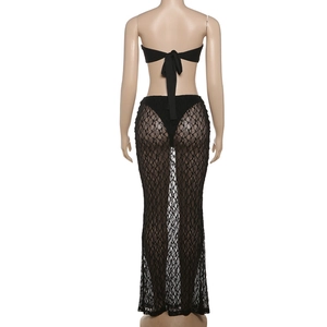 Detail view of the back of a black lace beach set with tie-up tube top and maxi skirt
